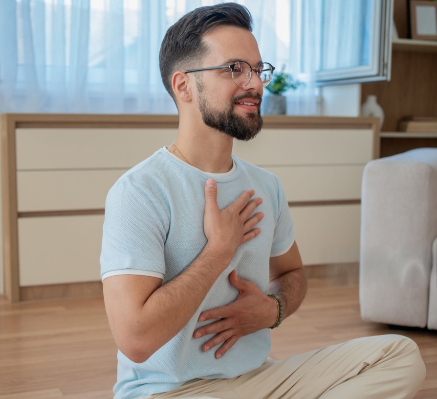 Person practising breathing with a hand on chest
